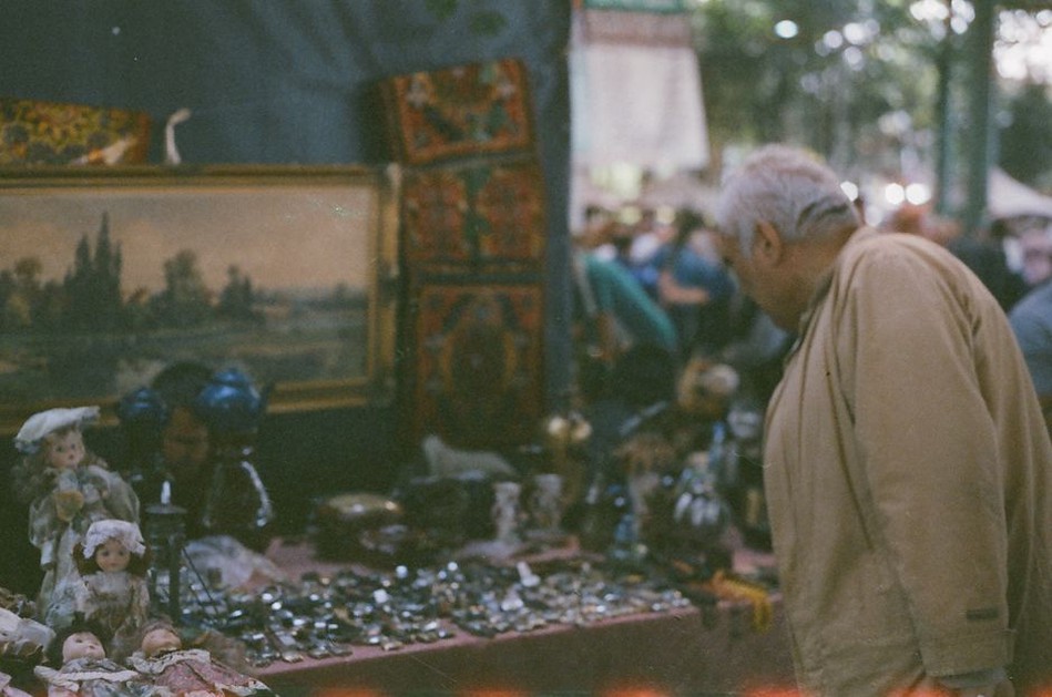 A market stall in an English town showing vintage combs and clips on burgundy velvet