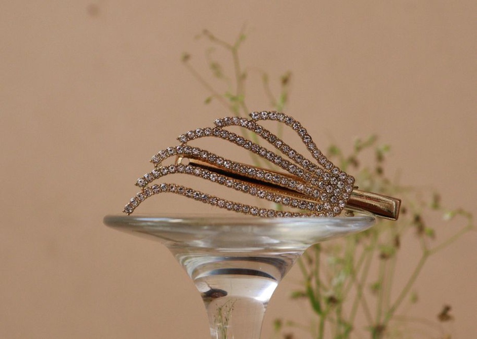 Sterling silver crescent barrette with clear paste stones on a velvet display