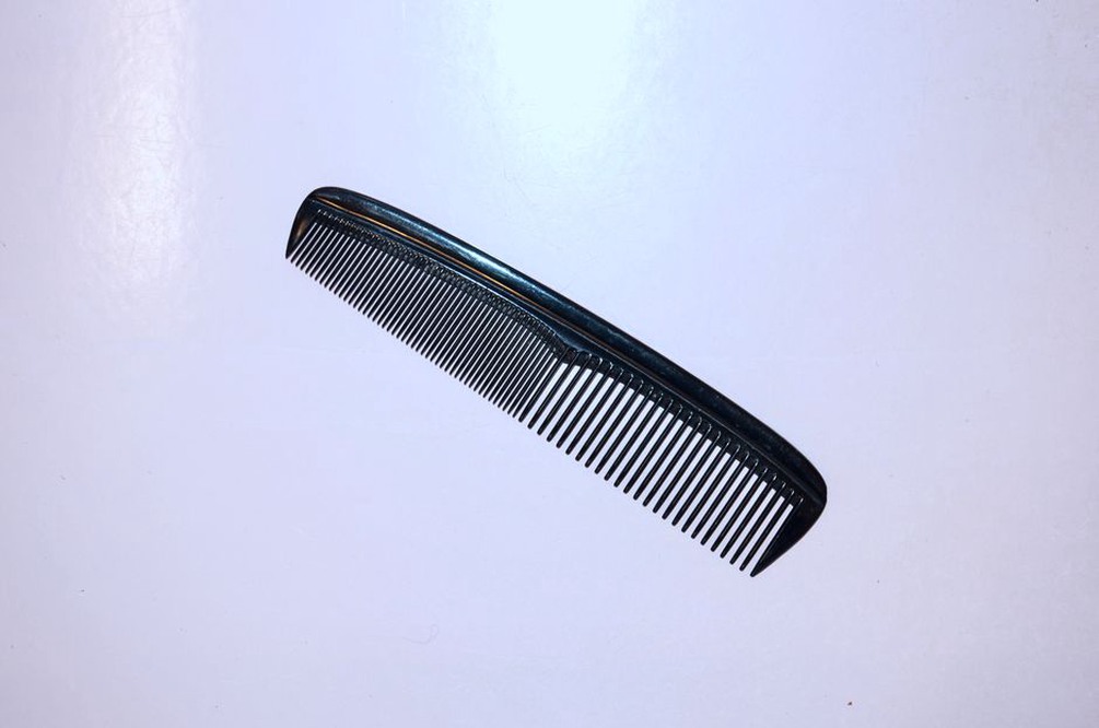 close-up of a shell-pattern hair comb with warm aged patina