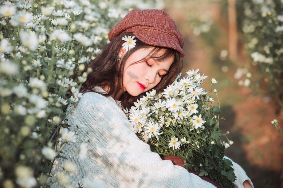 Close-up of hand-stitched daisy applique on a black beret