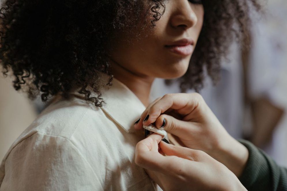 woman styling a vintage resin bow barrette in a half-updo