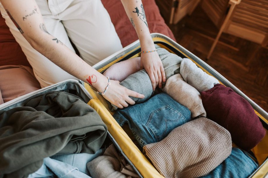 Folding a delicate 1970s rayon dress with care