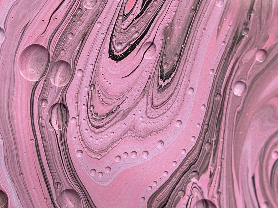 Swirling rose and cream acetate grain visible on a vintage hair claw surface