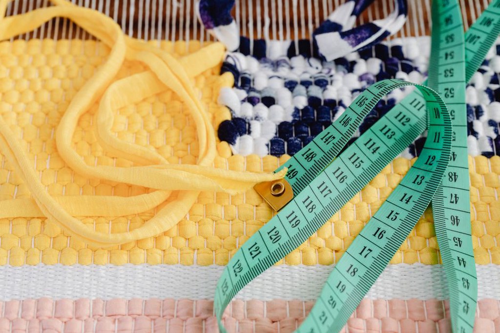 Hand-stitched smiley face on natural raffia basket clip