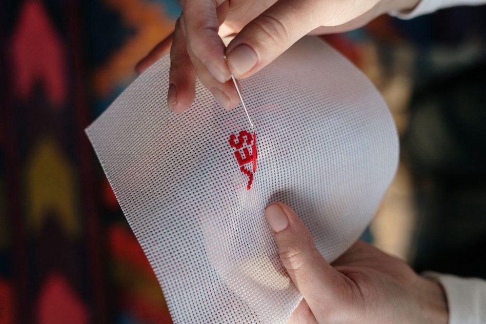 Detailed view of hand stitching on a vintage velvet twist headband