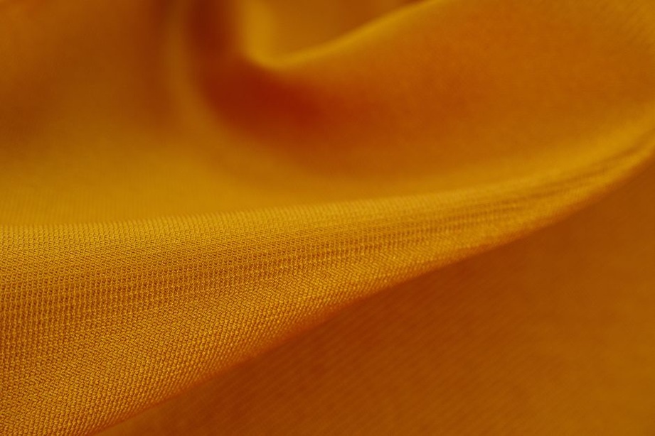Detail of ribbed fabric and tiny gathers on a yellow scrunchie