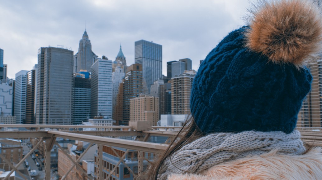 Close-up of a hand-knitted wool pom pom beanie with a fluffy pompom