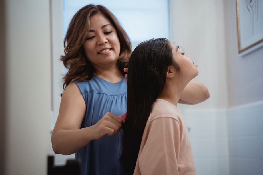 Mother and daughter examining Edwardian hair combs together