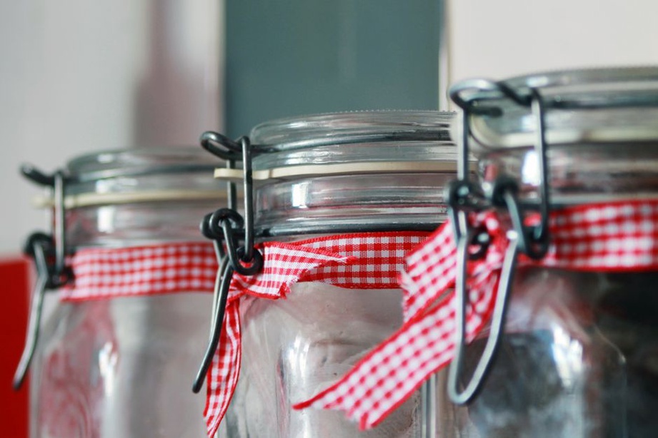 Red gingham bow barrette resting on a wooden vanity surface