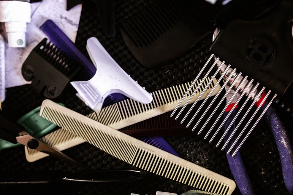 Silver-toned vintage combs arranged on dark velvet