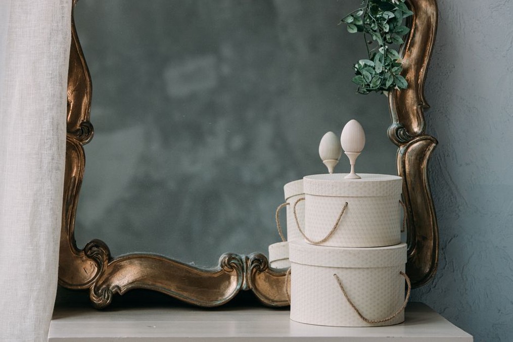 Three cloud-shaped lobes on a vintage hair clip resting on a wooden vanity surface