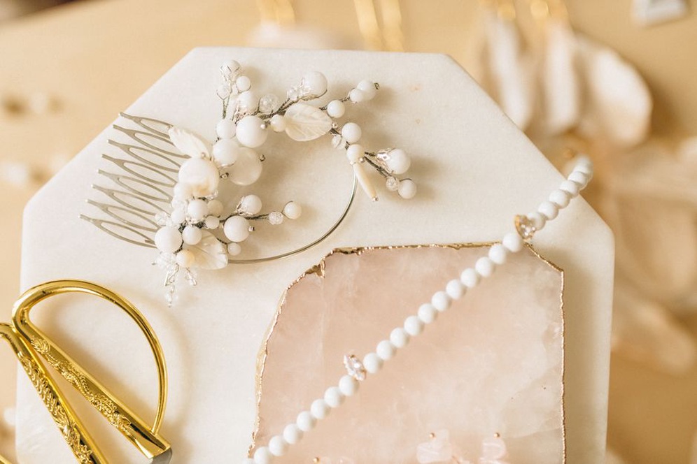 Pearl White Bertha comb displayed on dark velvet background