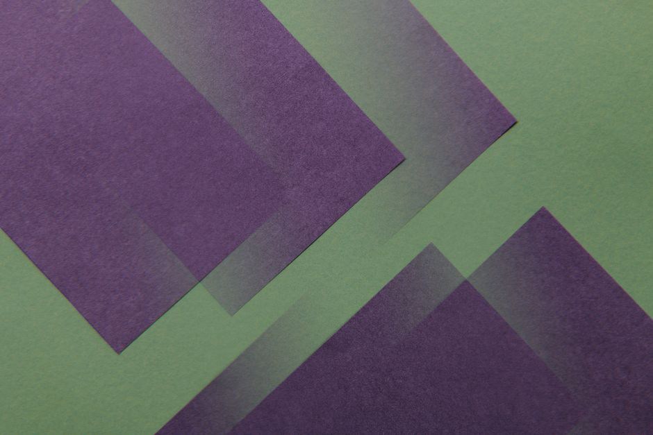 Vintage violet and green celluloid combs on a wooden table