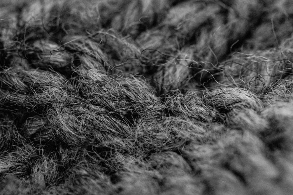 Close-up of a hand-crocheted wool beret showing stitch detail and soft texture