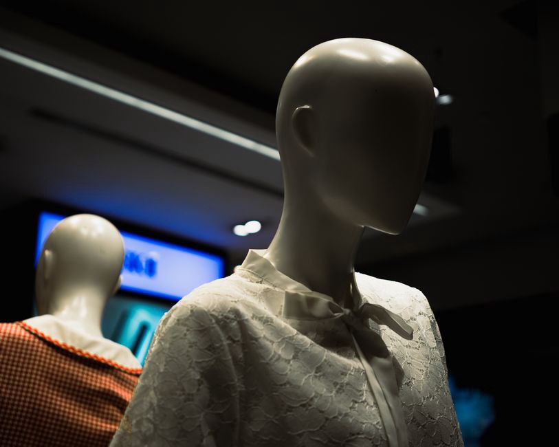 Gingham top knot headband displayed on a vintage mannequin, showing the gathered fabric bow at the crown