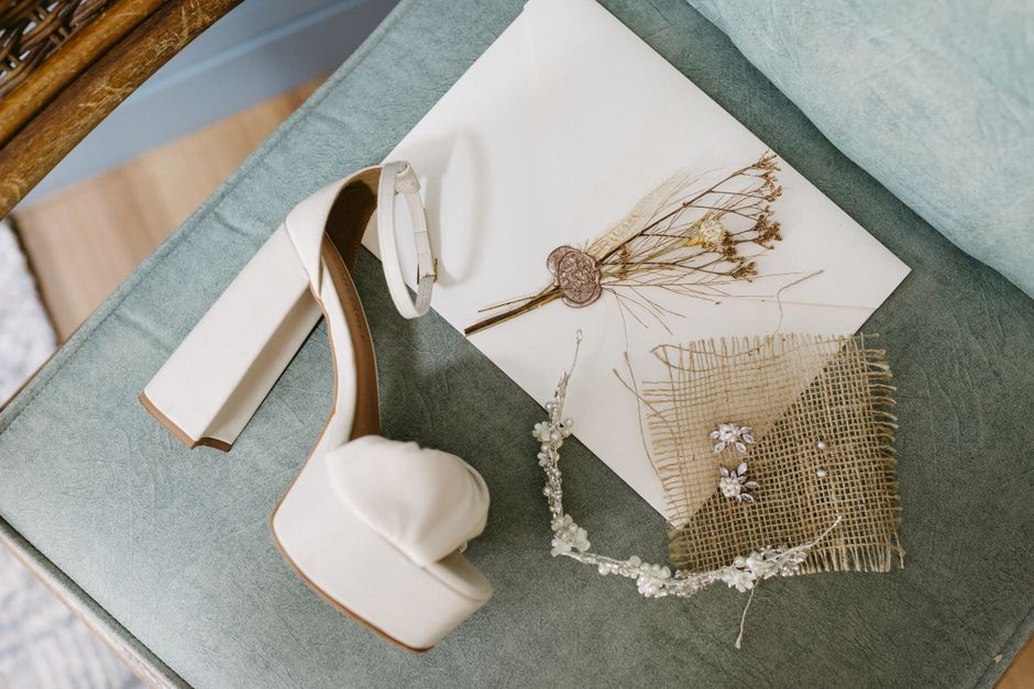 Olive-toned braided headband resting on linen surface