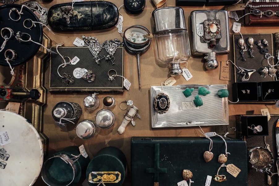 Antique combs and clips arranged on a velvet cloth at a sale