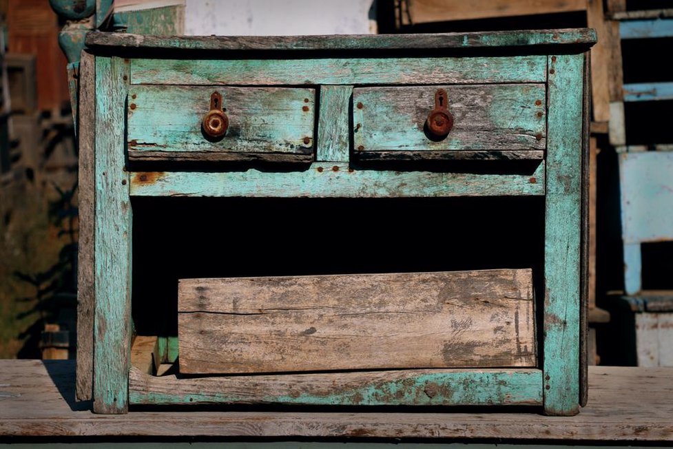 hair accessories resting on an antique dresser, each showing honest wear