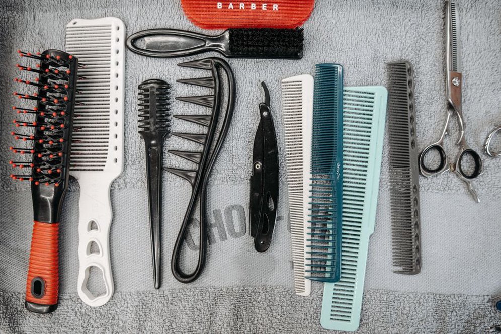 Edwardian and Georgian combs displayed on antique lace