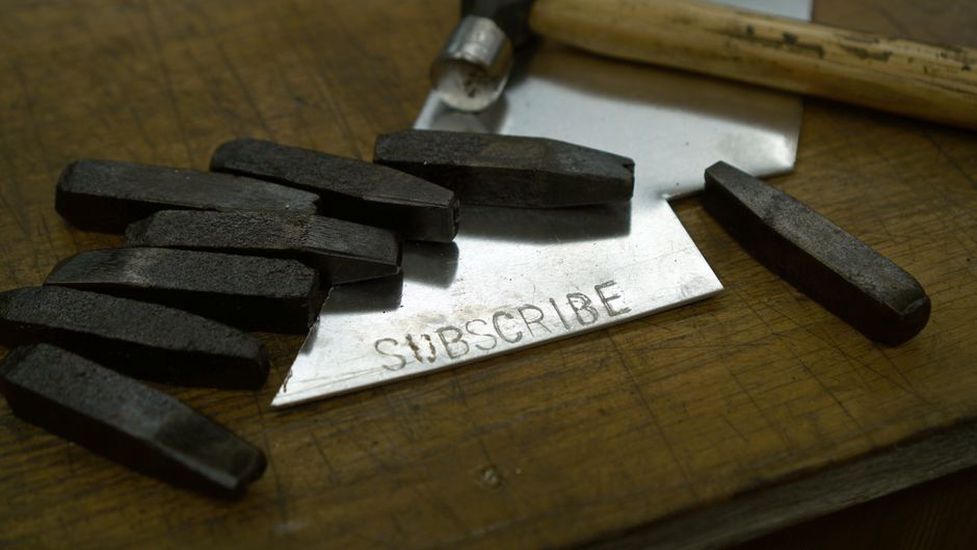 Underside of a scalloped hairclip showing metal stamp and hinge mechanism