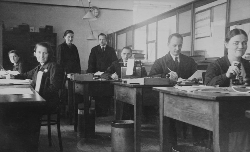 Workers shaping horn combs at a London factory bench around 1910