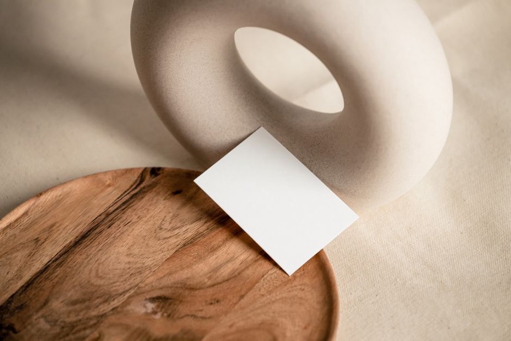 Ivory hair clip with gentle curved silhouette resting on aged wood