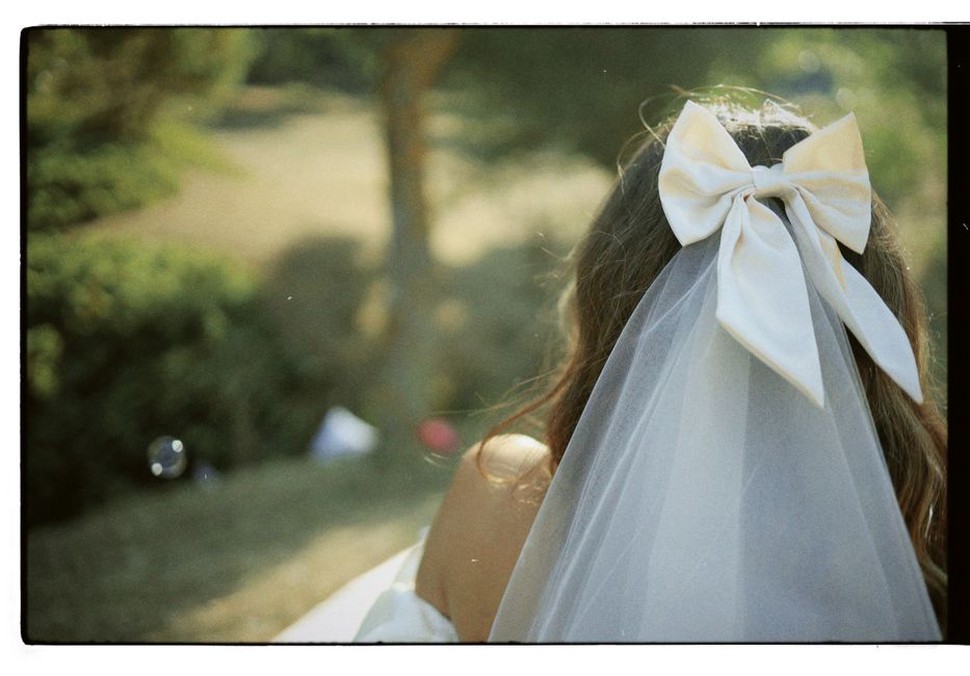 reverse of navy blue hair bow with metal clip and sewn-in manufacturer label