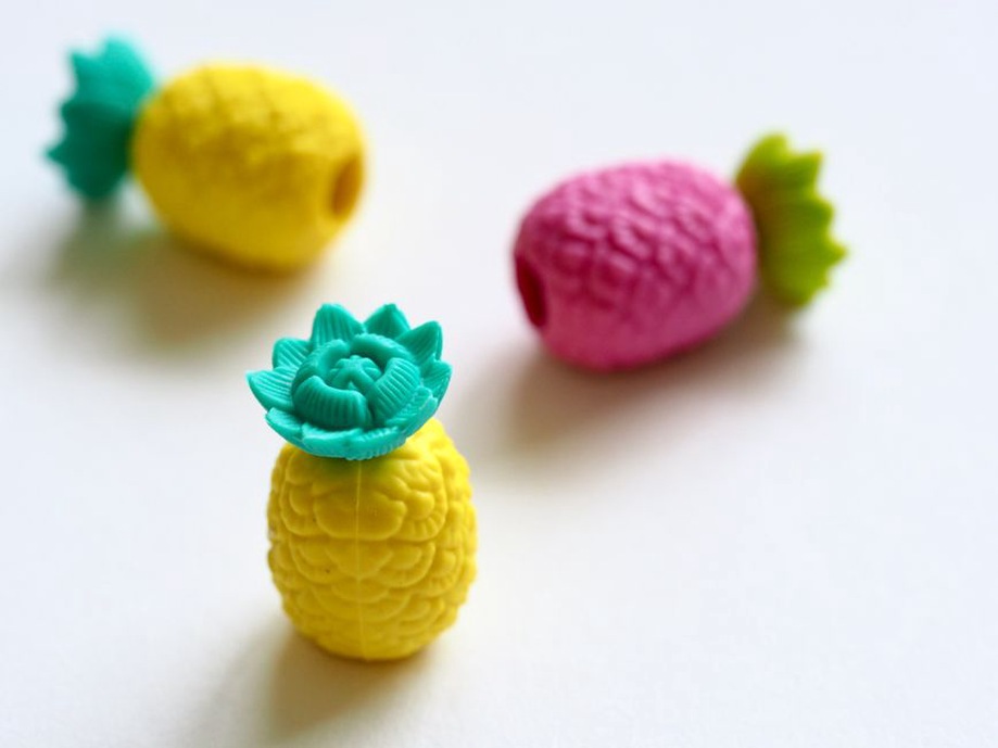 yellow resin pineapple claw with green leaf detail on a white saucer