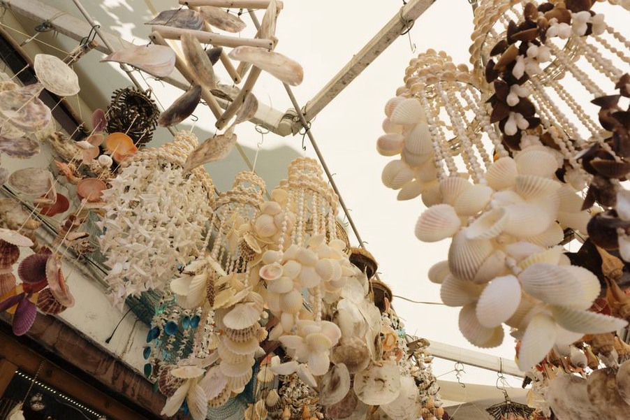 strand of cream puka shells resting on a linen textile