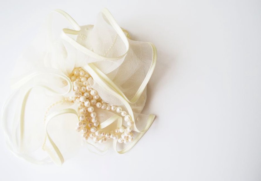 romaine silk barrette with wrapped edges resting on linen