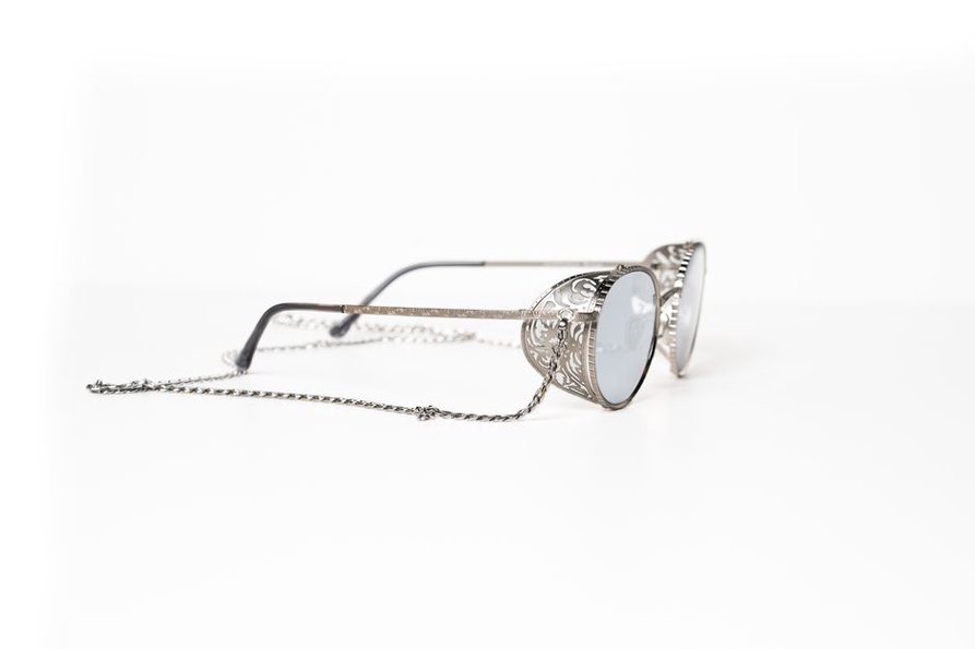 Close-up of a matte silver glasses chain clasp marked p396