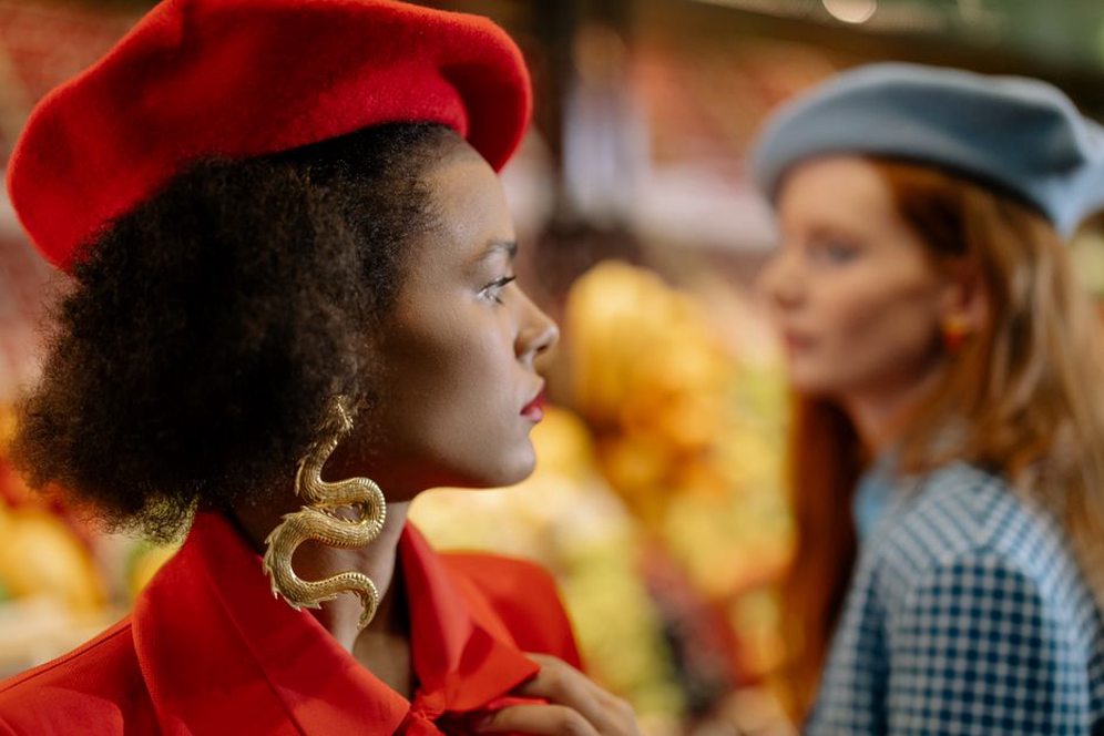 Close-up of a 1920s velvet snake beret with a coiled metal snake ornament