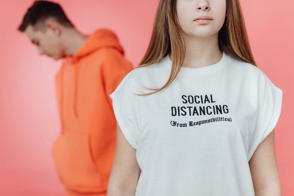 A collection of vintage t-shirts with humorous British slogans displayed on hangers