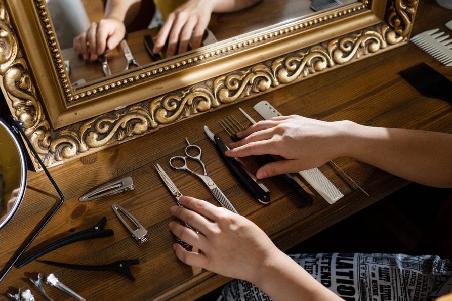 Two tortoiseshell combs resting beside a vintage mirror