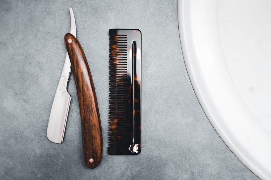 Three vintage tortoiseshell-effect combs displayed on cream linen
