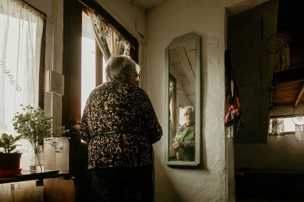 Reflected view of a leopard print headband being positioned in a dressing table mirror