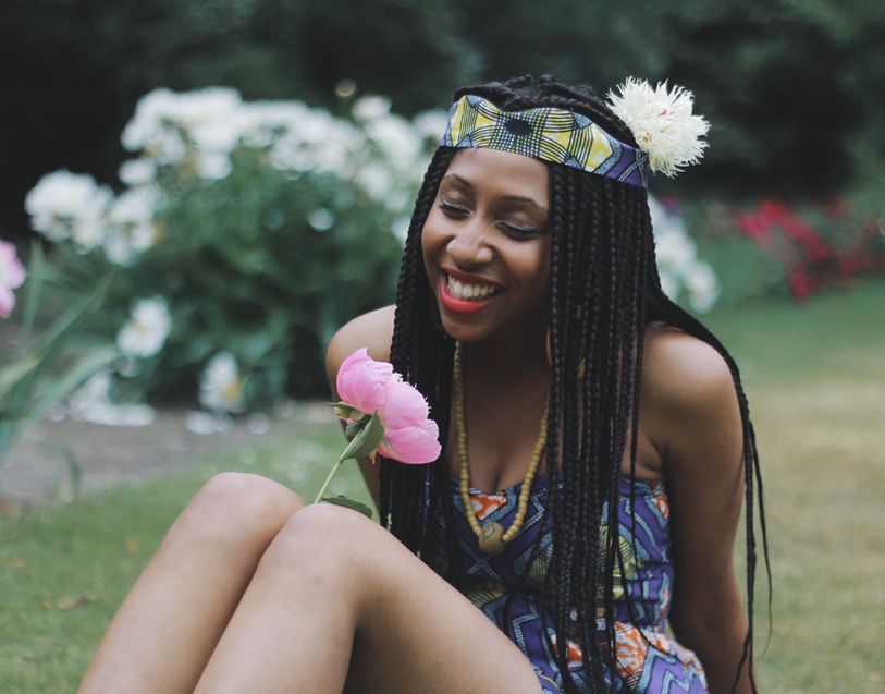 Brunette in floral sundress styling a red gingham braided headband