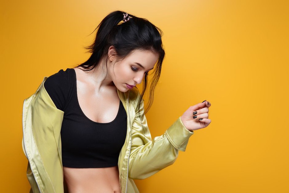 Half-up hairstyle secured with a black velvet scrunchie, woman wearing a tailored blazer