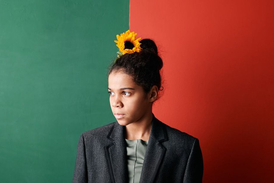 Black velvet bow against forest green wool blazer