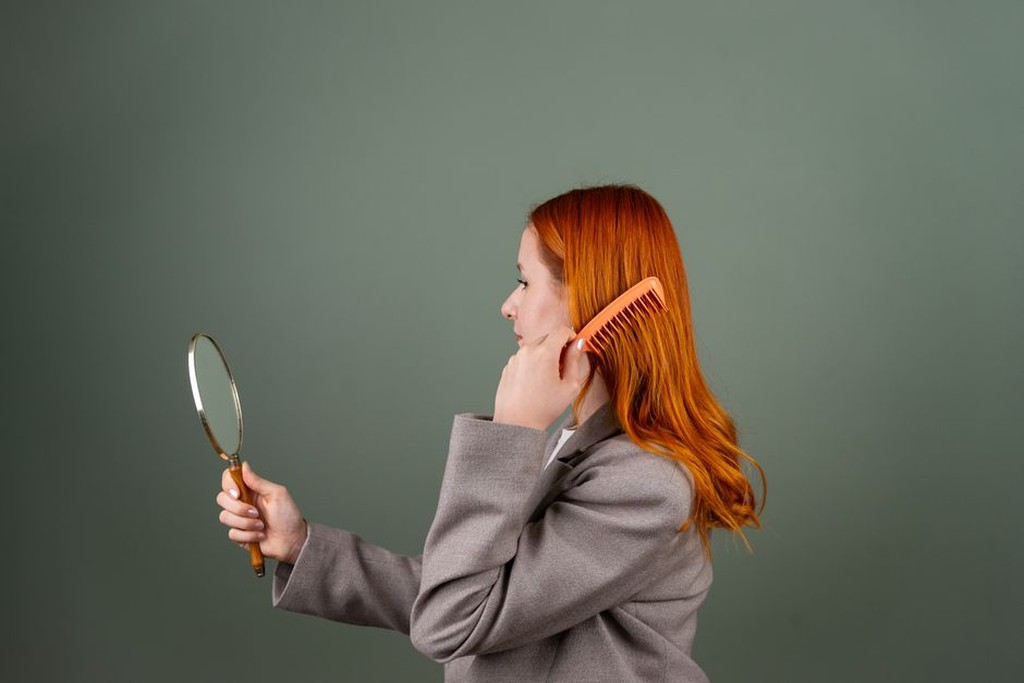 A modern woman inserting an amber resin comb into a loose bun