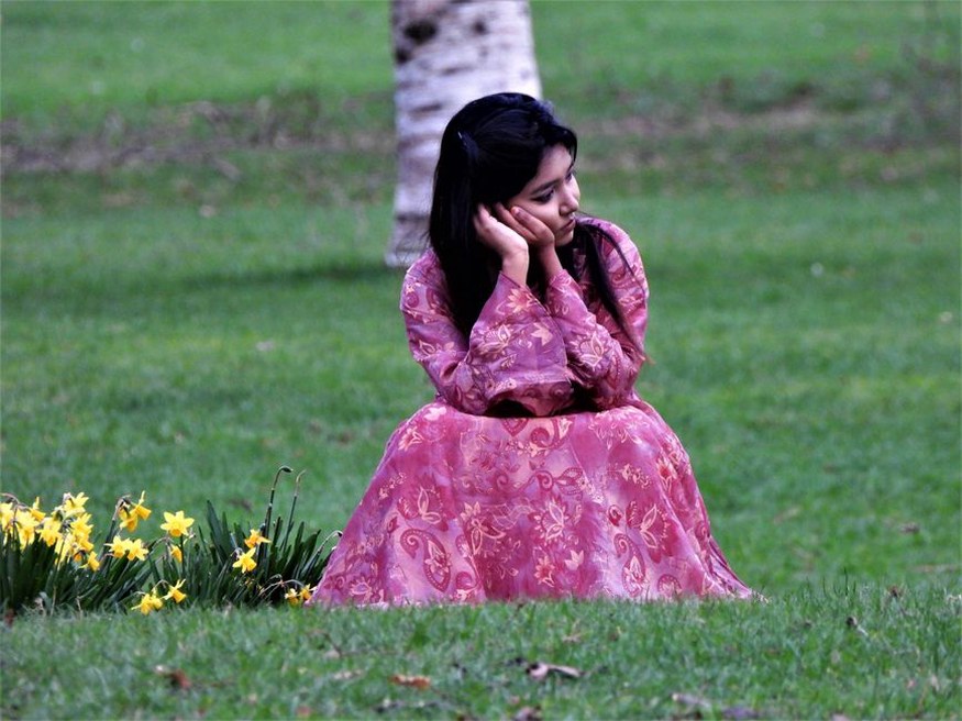 Vintage floral maxi dress worn with a straw hat in natural light