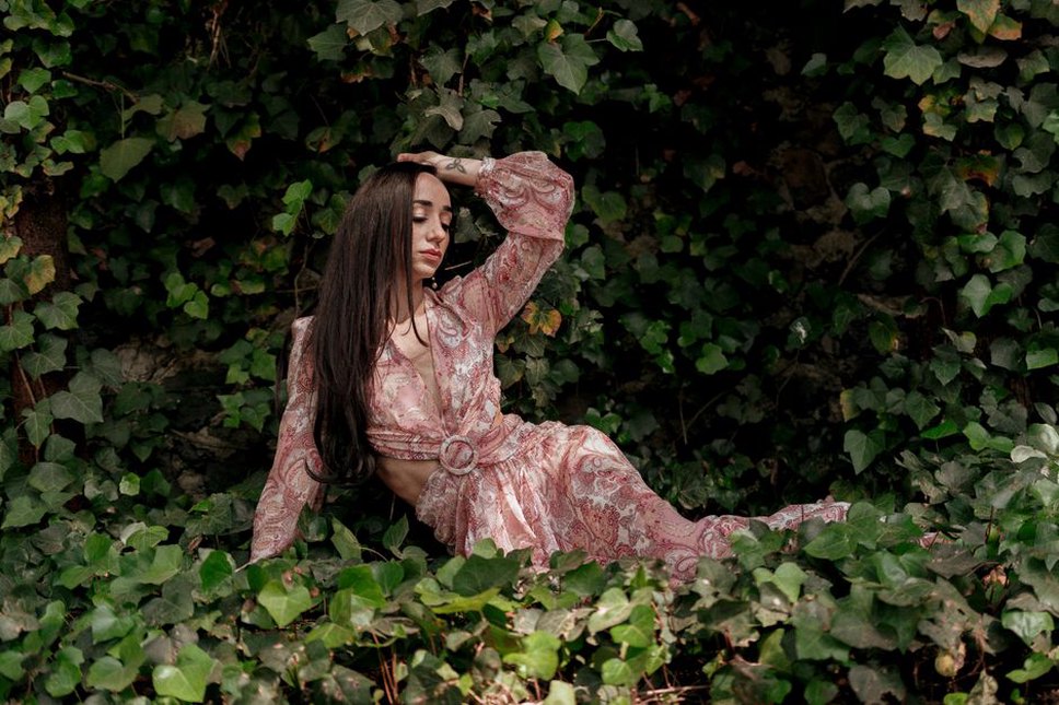A floral maxi dress styled with a tortoiseshell hair clip in a garden setting
