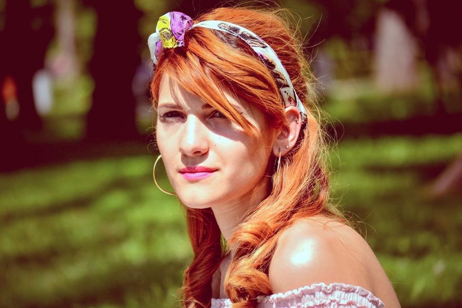 1960s hairstyle with orange satin squared headband and pearl earrings