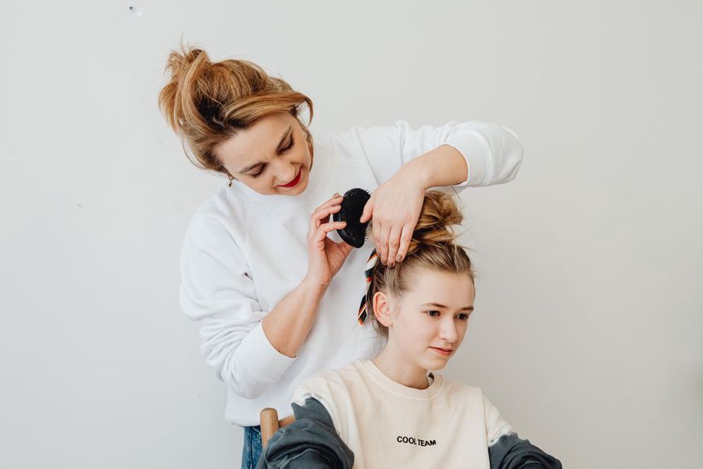 Modern woman with a low bun and a mocha comb accent
