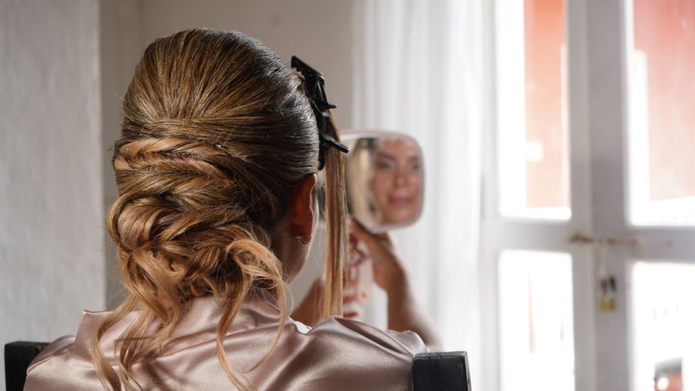 Low bun secured with a scallop-shaped claw clip in a modern neutral outfit