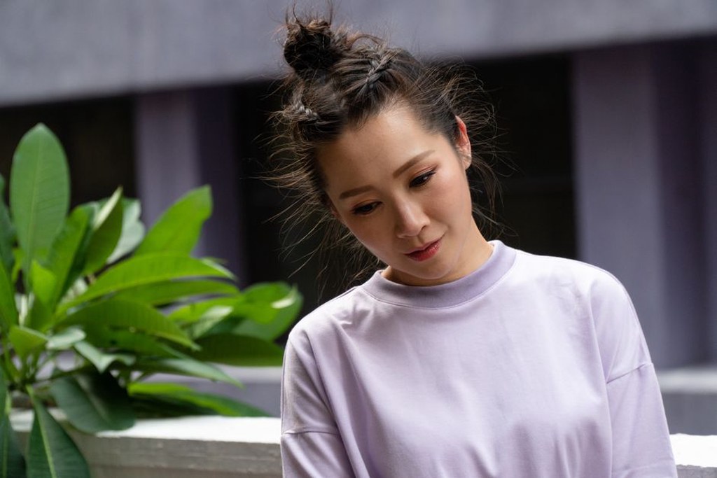 A contemporary outfit styled with a vintage oval barrette securing a low bun
