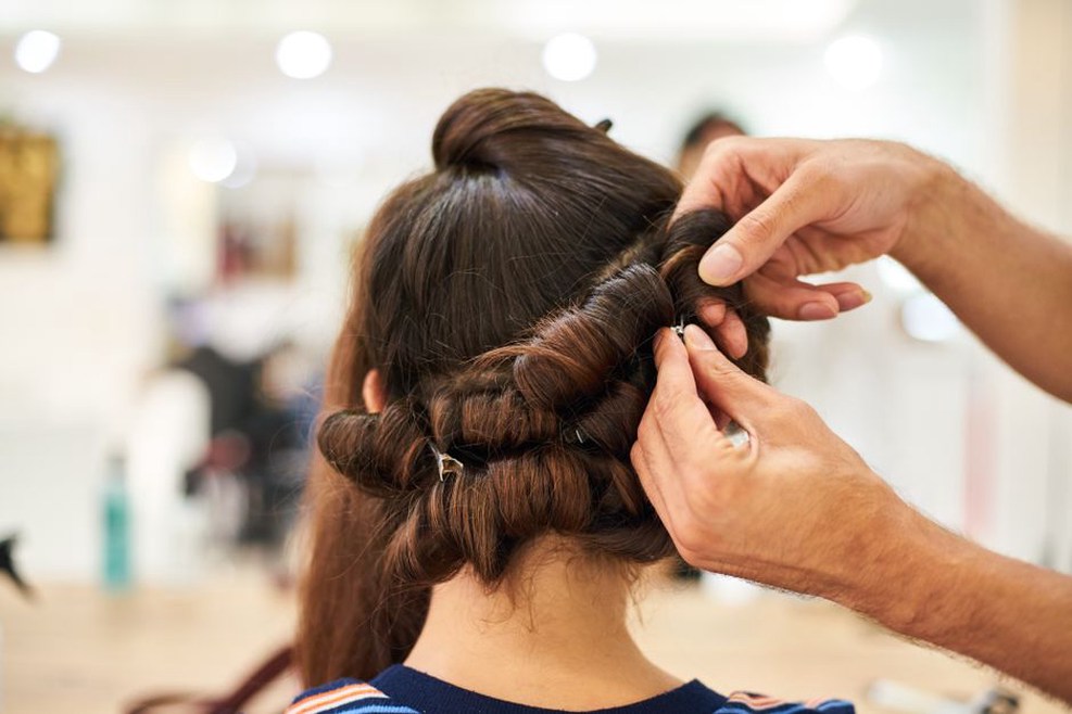 a brunette wearing a lilac Buttercups midi clip in a low chignon, styled with a cream blouse