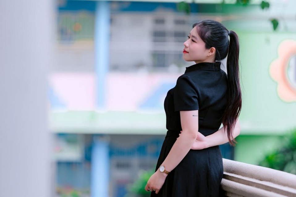 Velvet bow securing a low ponytail with tailored clothing