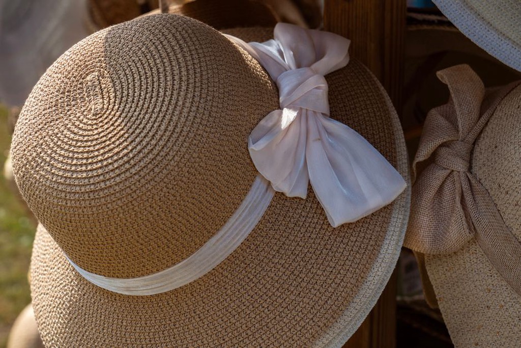 Flat ribbon trim beside an angled brim
