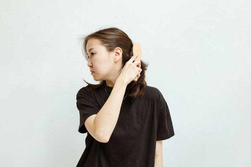 A carved comb paired with a simple dark outfit
